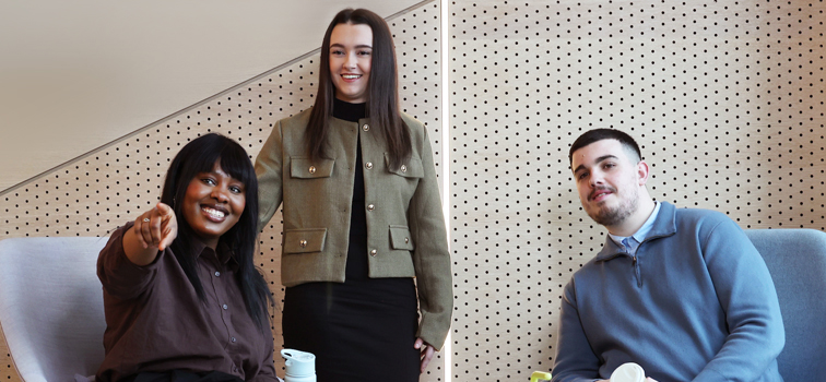 Three interns in conversation.