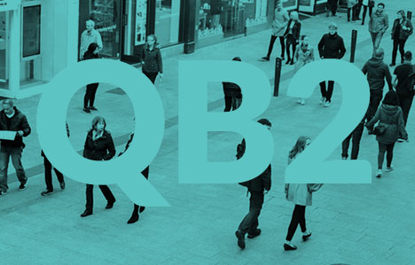 People walking on a street with a green monochrome and QB2 text over image
