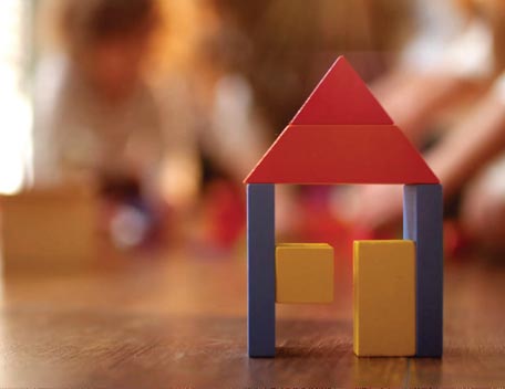 Toy bricks with a red triangle, and two blue legs and three squares with background shaded out