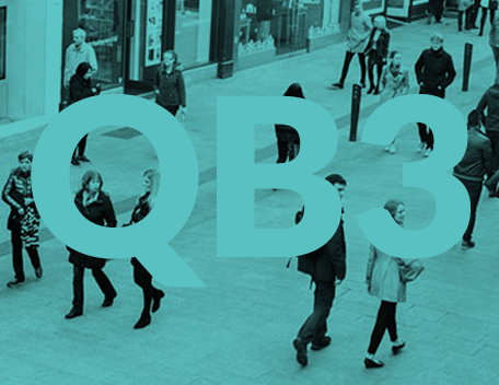 People walking on a street with a green monochrome shade with QB3 written on image
