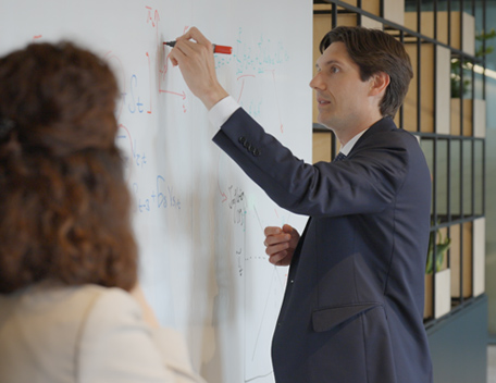 Suited man drawing on a whiteboard