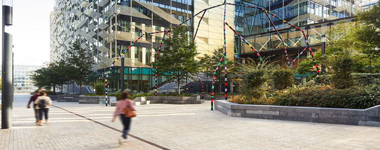 A few people walking on path at Central Bank of Ireland building